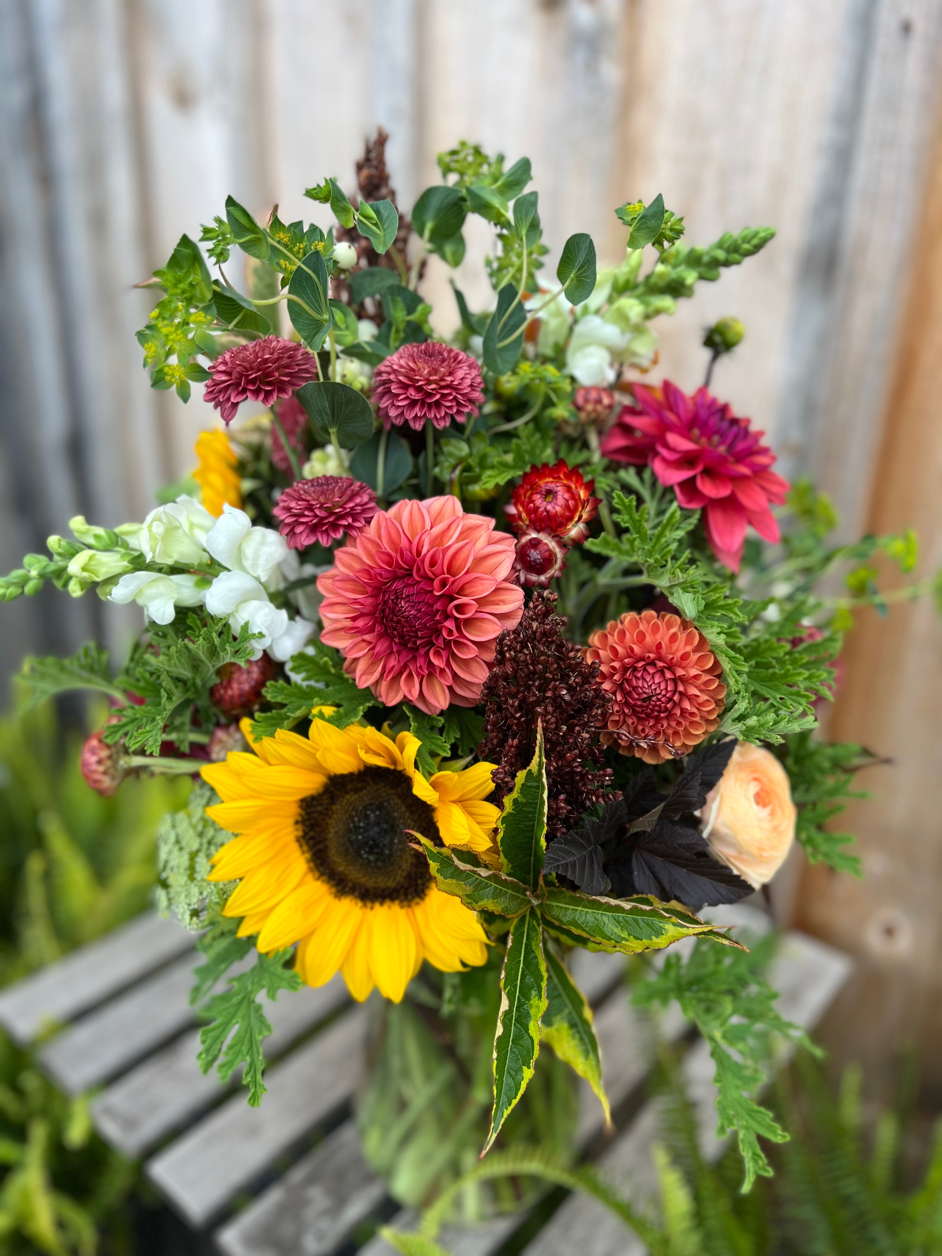 Large artificial flowers in shop vase